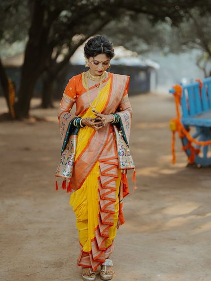 A candid moment showing the intricate pleats of the Nauvari saree.