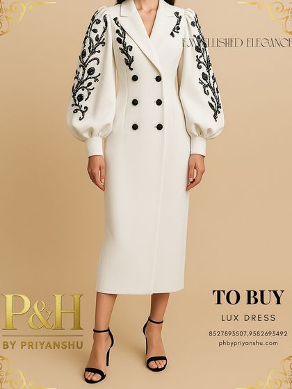 A detailed shot of the white double-breasted dress, focusing on the exquisite black hand-embroidery on the voluminous sleeves.