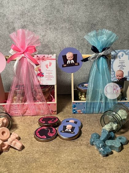 Make your baby announcement special and unforgettable with our beautiful hampers. This image shows our "Boss Baby" and "Barbie" themed favours, perfect for announcing a boy or a girl.
