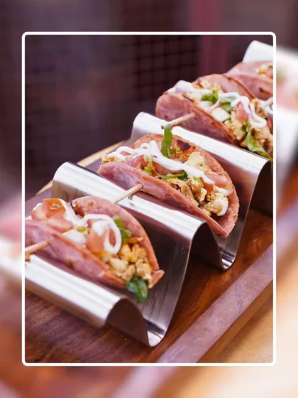 A close-up of my paneer tacos served in a sleek, wavy metal stand. The presentation is modern and clean, making it easy for guests to pick up and enjoy.