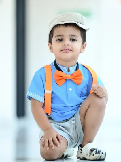 Another shot of the stylish little boy, posing with a cool, relaxed attitude.