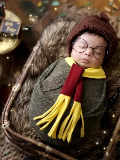A close-up of our little wizard, peacefully sleeping in a basket. We ensure your baby is always comfortable and safe, even in our most elaborate themed setups.