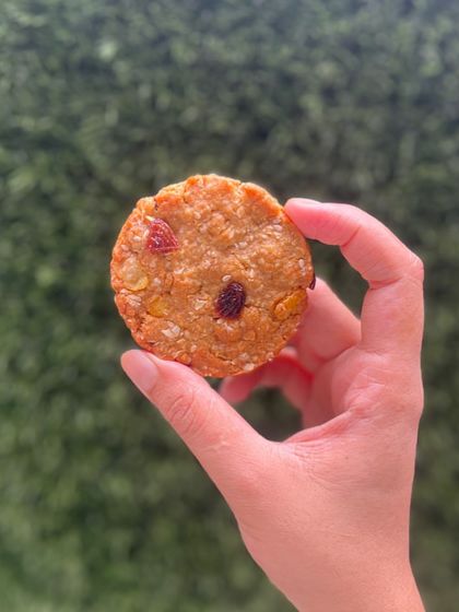 The Anzac Cookie, a hearty and wholesome treat made with honey, oats, sesame, and raisins. A perfect guilt-free snack.