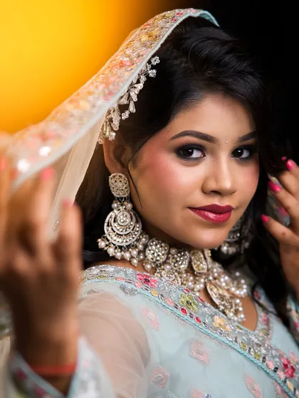 The sheer dupatta adds a touch of grace to this engagement or reception look, with the makeup kept fresh and glowing.