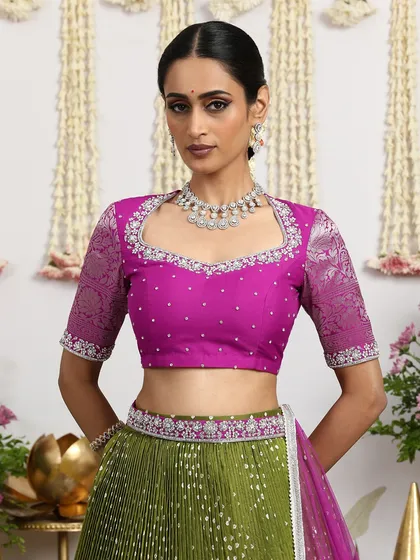 A close-up of the magenta embroidered blouse, showcasing the intricate detailing and the beautiful brocade sleeves.