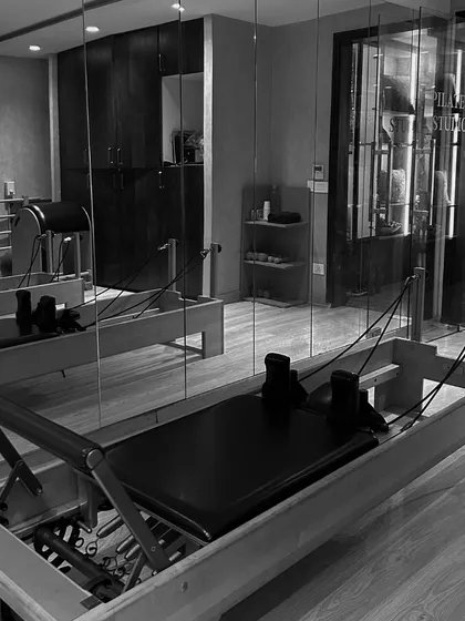 A quiet moment in the Pilates studio, showcasing the classic reformer. This machine is central to my practice, offering versatile and effective full-body conditioning.