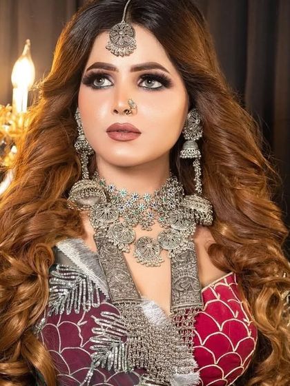 A glamorous Navratri look featuring a heavy, intricate oxidised silver necklace and matching earrings.