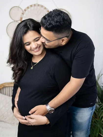 A sweet and playful moment between the couple. Capturing these natural interactions is key to a successful lifestyle maternity photoshoot.