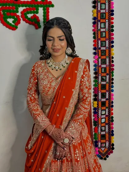A close-up of the soft glam makeup, featuring a neutral eye and a warm lip color that perfectly complements her orange engagement attire.