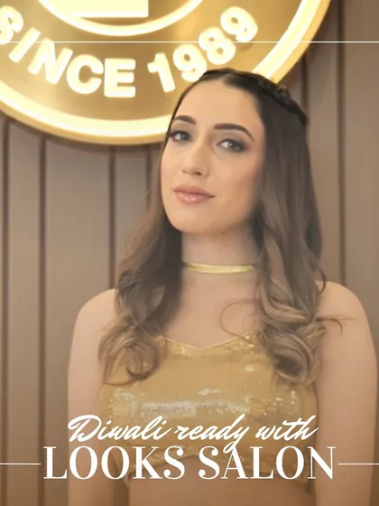 A close-up of the model's Diwali look, showcasing her smoky eye makeup and the festive glow.