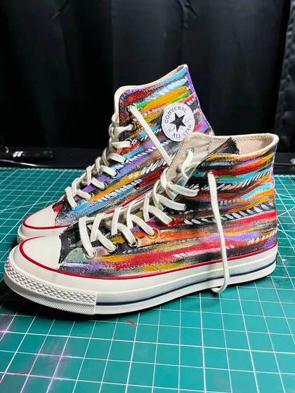 Another view of the abstract painted Converse high-tops on my work mat.