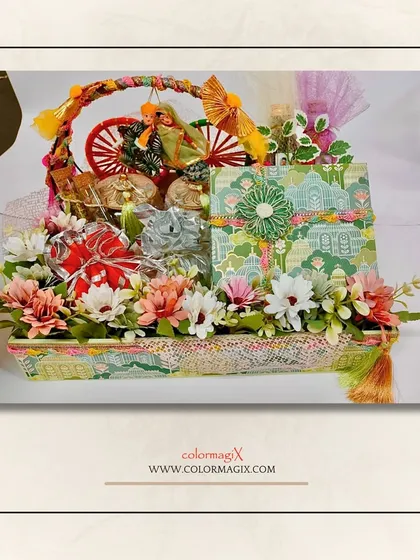A beautifully arranged Lohri basket, adorned with flowers and tassels. It’s a modern take on traditional gifting, perfect for sharing the warmth of the festival.