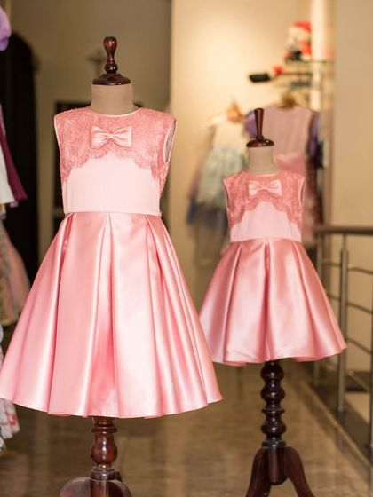 A perfect pair of pink satin dresses for sisters. I created two sizes of the same elegant design, featuring a lace bodice and pleated skirt, for a stunning matching look.