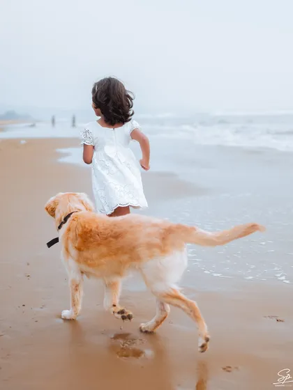 Family means everyone, including the furry members. This shot of a girl and her best friend running towards the waves captures the carefree energy of childhood. I always welcome pets to join in on our family photoshoots.