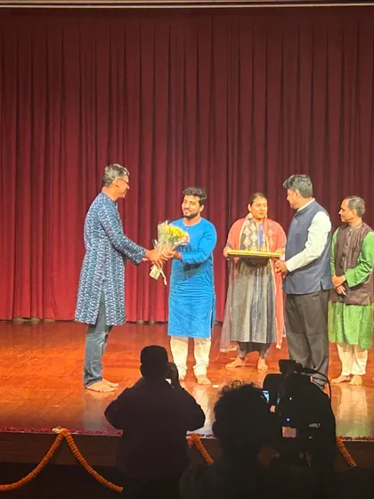 Receiving a token of appreciation on stage at the Debadhara Delhi concert.
