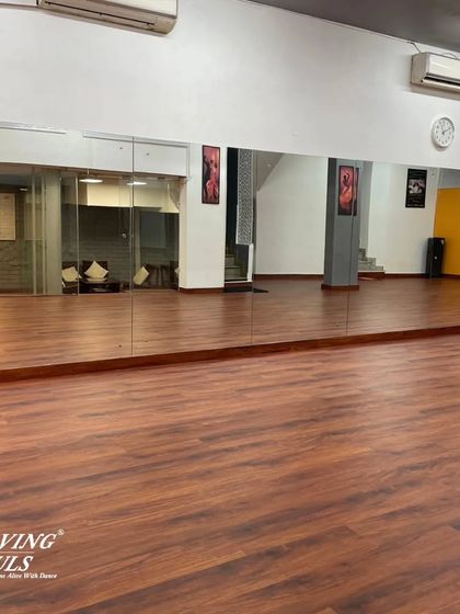 The full expanse of our wooden dance floor and mirrored wall, providing the perfect environment for learning and practice.