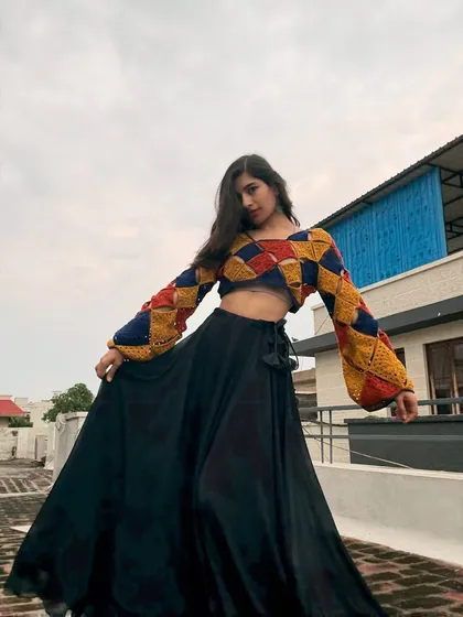 This colorful patchwork crop top is one of my favorite makes. I love playing with geometric patterns and bold colors to create something truly unique. It's made with soft cotton yarn and has fun bell sleeves, perfect for making a statement.