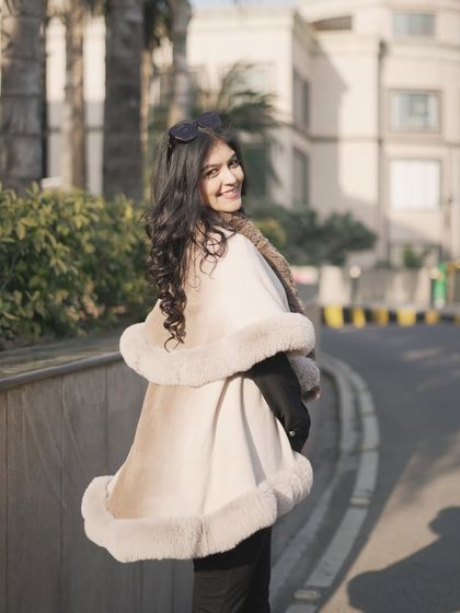 Fur and I are winter besties. This beautiful beige and brown fur-trimmed cape is a chic and elegant layering piece for the colder months.