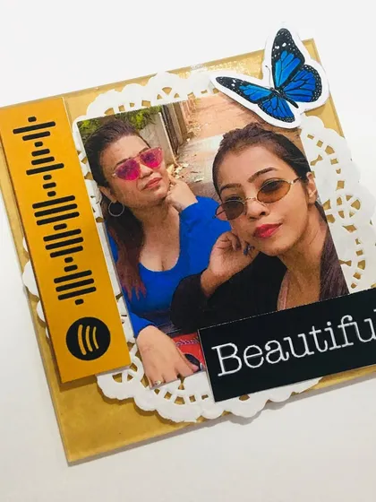 A close-up of my handmade mini acrylic frame, featuring a Spotify code and a "Beautiful" sticker. It's a modern and stylish way to display a photo.