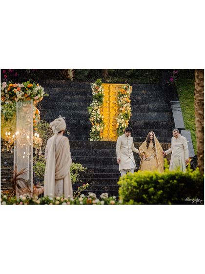 The bride's grand entrance down a stunning staircase for her destination wedding in Udaipur.