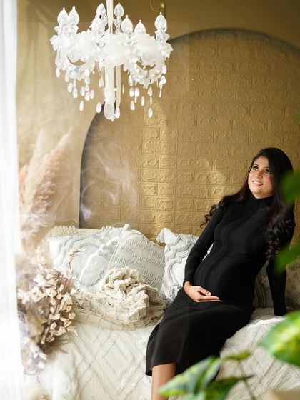 Another beautiful solo portrait of the mother, framed by soft light and greenery, radiating peace and joy.