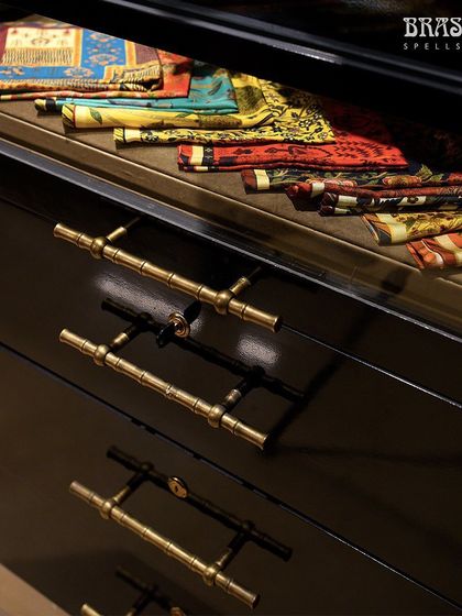 Another view of the Bamboo T-knobs on black lacquer drawers, showcasing their versatility against different materials and textures.