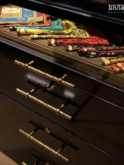 Another view of the Bamboo T-knobs on black lacquer drawers, showcasing their versatility against different materials and textures.