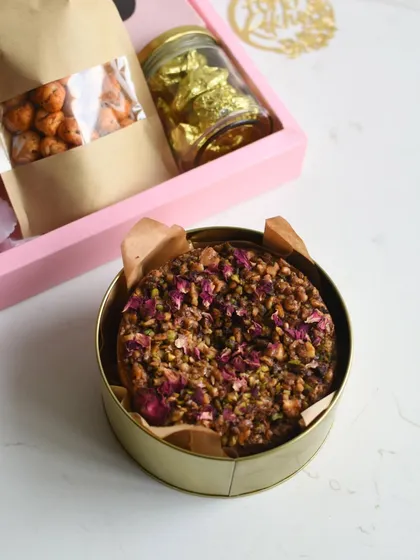 A close-up of the Baklava Tea Cake from my Rakhi Hamper, topped with nuts and rose petals.