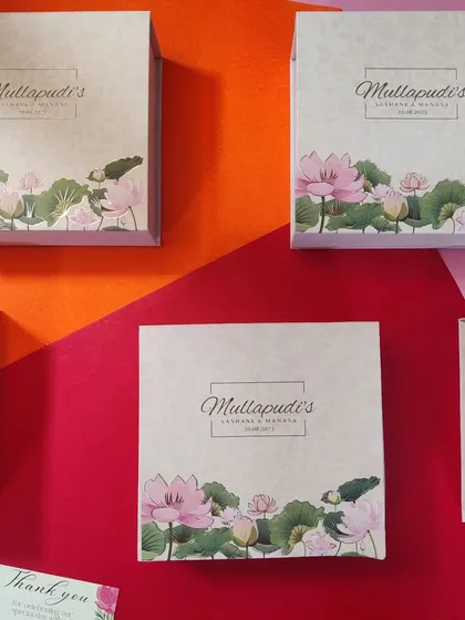 Personalized wedding favors are one of our specialties. These custom-designed boxes feature a beautiful lotus motif and the couple's logo, creating a thoughtful and elegant giveaway for guests to remember the special day.