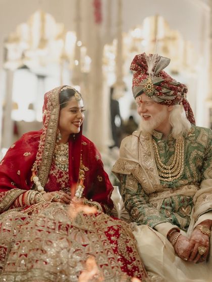 A candid moment of shared laughter during their wedding ceremony in Jaipur. This shot captures the genuine joy and easy connection between the couple, even amidst the formality of the rituals.