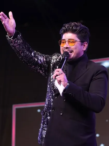 A dynamic shot of me on stage, engaging with the audience. My body language, my voice, and my energy are all focused on one thing: creating an unforgettable experience for every single person in the room.