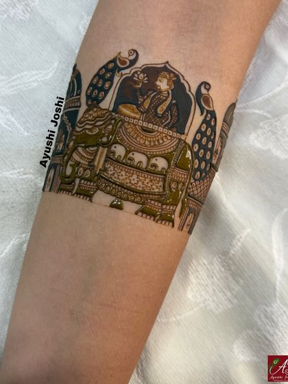 A unique design featuring a royal figure riding an elephant, flanked by peacocks. This is a great example of combining figurative and animal motifs.