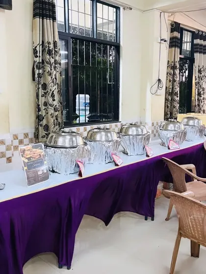A view of the buffet line with chafing dishes covered in foil to keep the food warm before service starts.