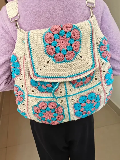 My daughter modeling the custom-made granny square backpack. It's so rewarding to see my creations being used and loved. This design is spacious, stylish, and truly one-of-a-kind.