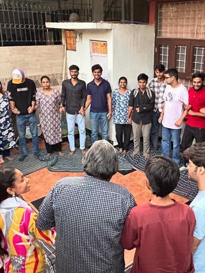 The entire group comes together in a circle, holding hands to close a training session. This ritual reinforces our values of community, trust, and shared purpose.