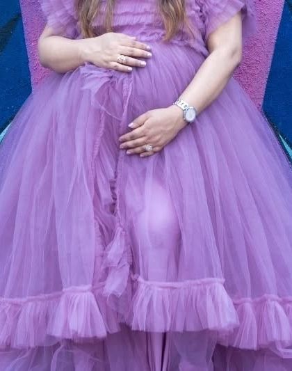 A close-up detail shot of a beautiful lavender tulle gown. This image highlights the delicate fabric and texture of the maternity dresses I offer for my sessions.