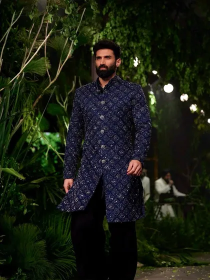 To match the raw, organic feel of Kunal Rawal's collection, I transformed the runway into a moody, primordial forest. We used giant trees and dense, wild foliage to create an environment that felt both powerful and deeply connected to nature.