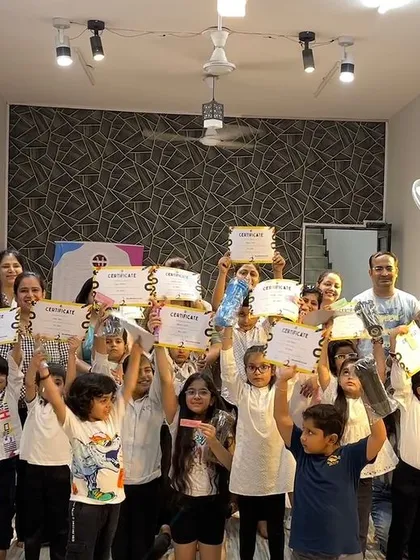 And that's a wrap on another amazing summer camp! This group photo with all the kids and their parents holding up their certificates captures the joy and sense of accomplishment we all feel at the end.