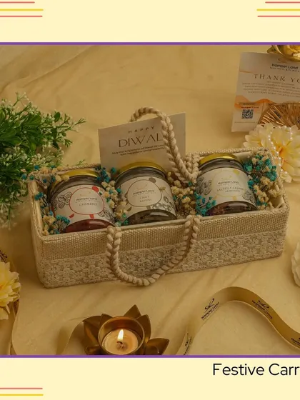 The 'Festive Carry' hamper. A simple yet elegant jute basket holding three jars of delicious treats, perfect as a thoughtful and handy gift for friends and colleagues.