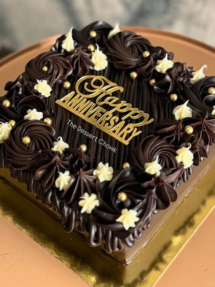 The full view of the square chocolate truffle anniversary cake.