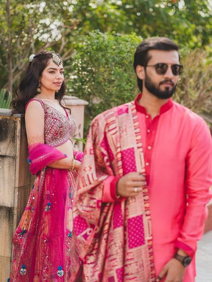 A beautiful, candid shot of a bride during her Haldi ceremony. Her hair is styled in a simple half updo, keeping it neat while still looking festive.