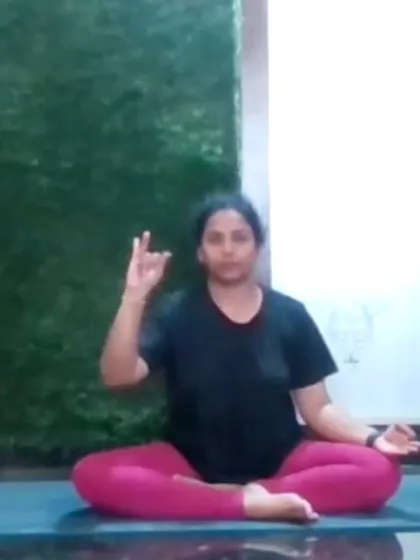 An instructor demonstrates a mudra (hand gesture) during an online pranayama session. Mudras are used to direct the flow of energy in the body and deepen the effects of the practice.
