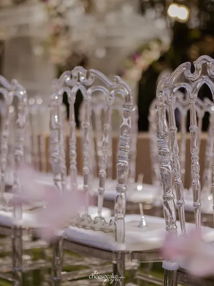 A detail shot of the elegant transparent 'ghost' chairs that lined the aisle.