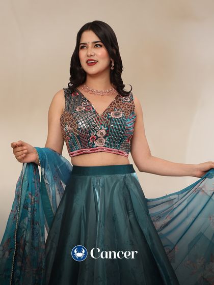 Cancer, your style is elegant and romantic. This teal lehenga with a beautifully embroidered blouse matches your graceful and intuitive vibe.