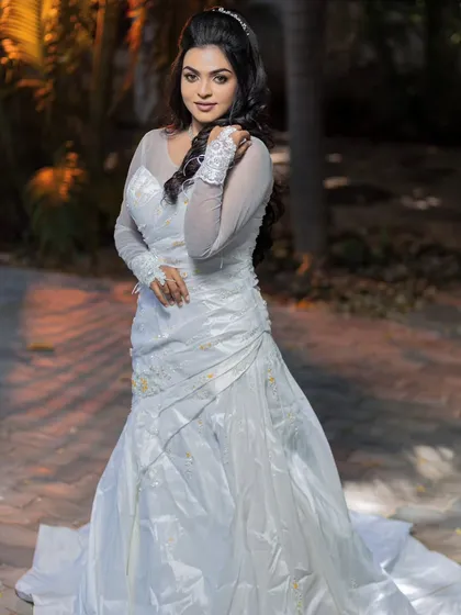 A full-length shot of a model in a white gown, perfect for a classic Christian wedding look.