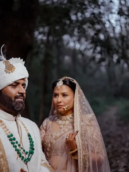A moody and cinematic portrait of a couple in a forest in Nainital, creating a fairytale-like wedding image.