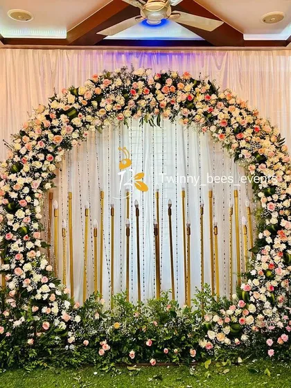 This full floral arch is one of our signature designs for engagements and receptions. We use a mix of fresh roses and baby's breath on a lush green base, creating a romantic and breathtaking backdrop for your special day.