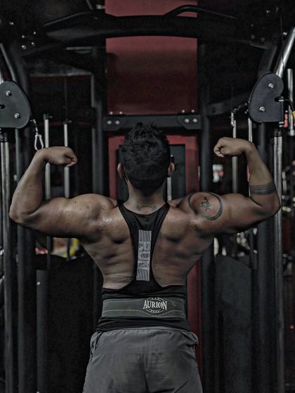 Spread your wings. A classic lat spread pose, showing the width of my back. This pose is all about creating an illusion of size.