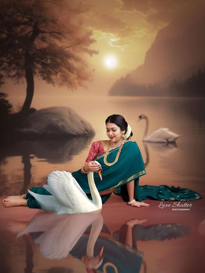 A beautiful interaction in this fine art portrait. The mother-to-be gently touches a swan, creating a magical and serene scene that feels like a fairytale.