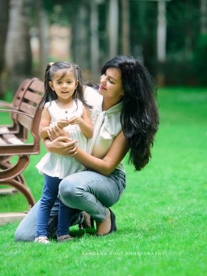 Another sweet moment from the same outdoor session, showing the gentle and loving bond between this mother and her little girl.